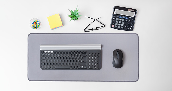 Wireless computer mouse and keyboard. Workspace at the office background, top view