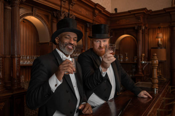 istock Two handsome 1920s style gentlemen in a luxury brown bar 1447122405