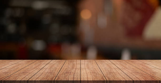 istock Empty wooden table top with lights bokeh on blur restaurant background. 1447123122