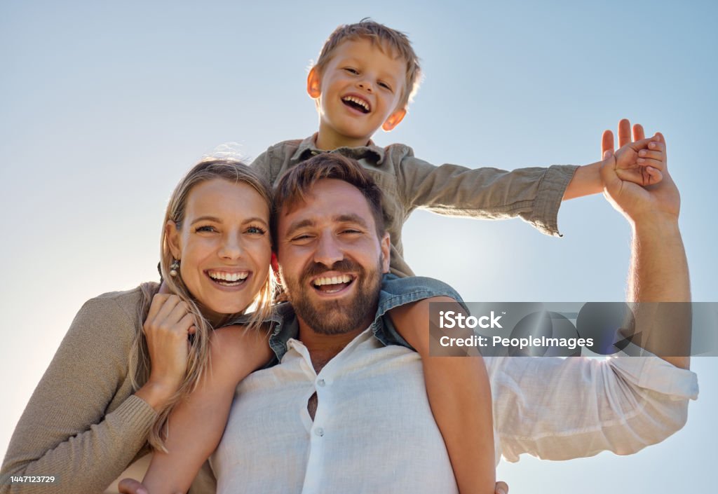 Family, mother and father with child, for holiday, vacation and being happy together outdoor. Portrait, mama and dad with kid for quality time, travel and bonding being loving, carry boy and have fun Family Stock Photo