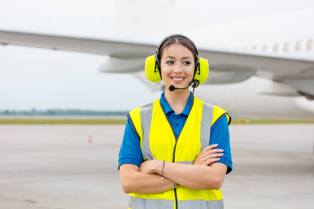 airport ground service, woman in front of airplane - ground crew audio imagens e fotografias de stock