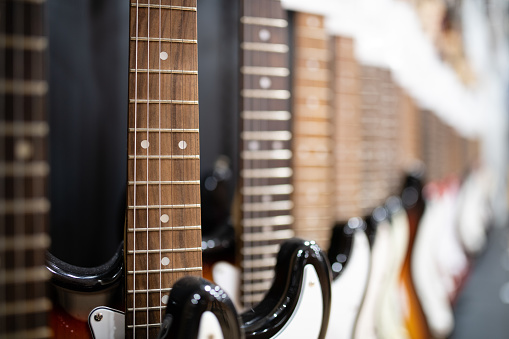 Many electric guitars lined up