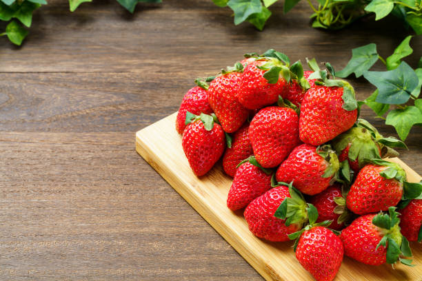istock Fresh strawberry fruits on wooden table 1447128737