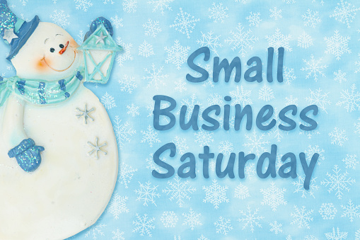 Small Business Saturday message with a winter snowman and snowflakes