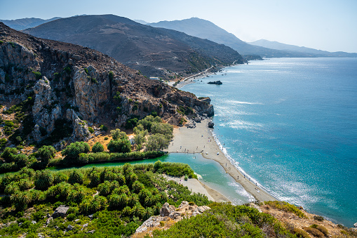 View of famous Preveli beach in the summer, Crete, Greece. Famous beach with river and palm trees in Libyan sea.