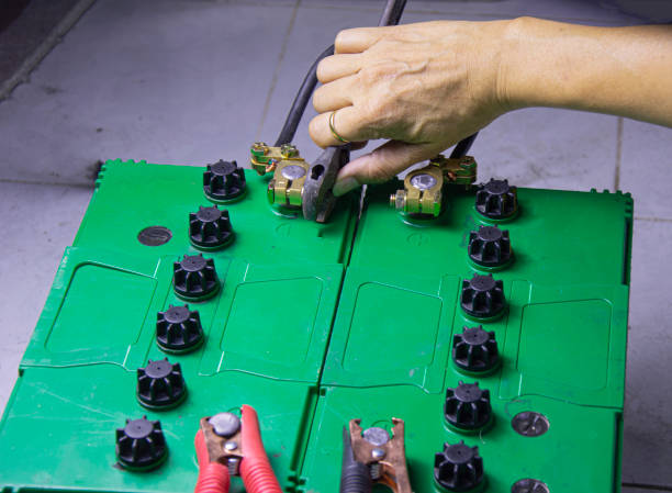 istock electrician connecting battery terminals 1447130302
