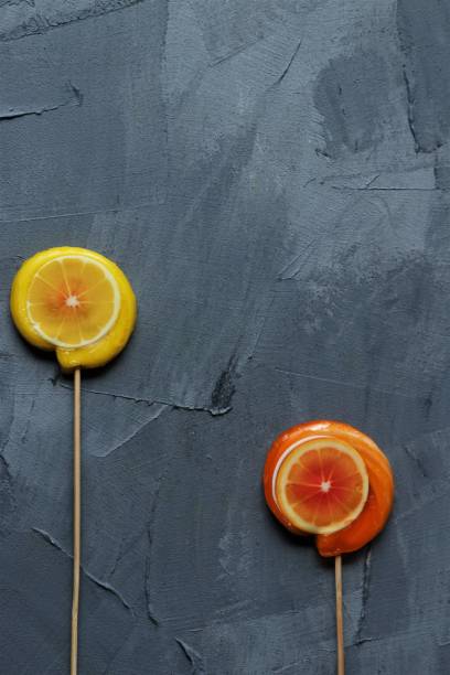 istock orange and lemon lollpop candies on a grey background 1447130504