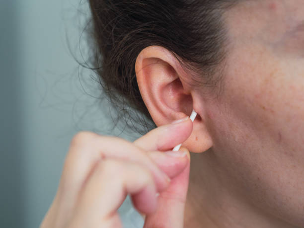 istock Caucasian woman's hand cleaning her ear. hygiene concept 1447130518