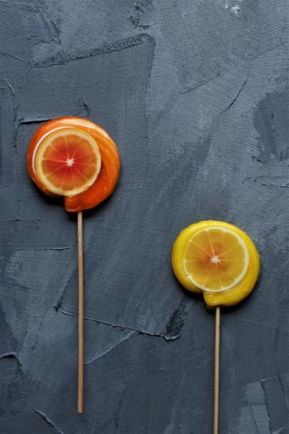istock orange and lemon lollpop candies on a grey background 1447130555