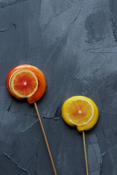 istock orange and lemon lollpop candies on a grey background 1447130579