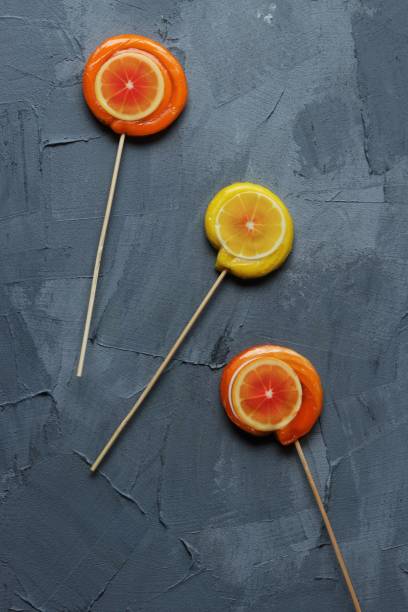 istock orange and lemon lollpop candies on a grey background 1447130587