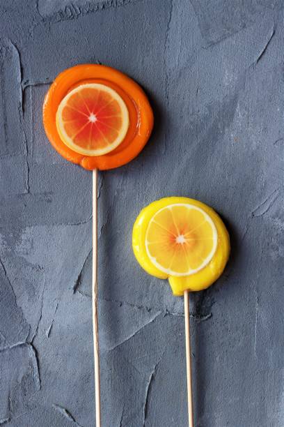 istock orange and lemon lollpop candies on a grey background 1447130598