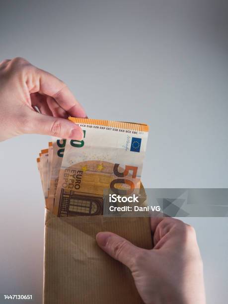 Womans Hand Taking Out Bribe Money In An Envelope Stock Photo - Download Image Now - Currency, Giving, Selling