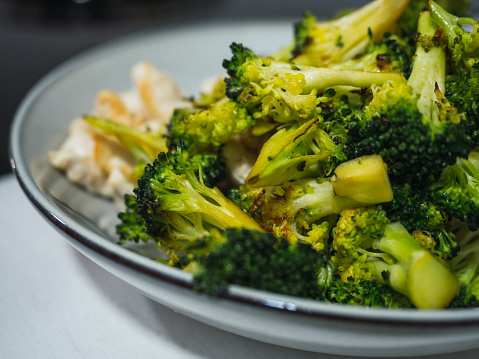 Close up of plate with broccoli. Healthy and vegan eating concept