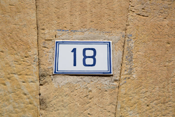 istock Closeup of Number Eighteen on Stone Wall 1447130992