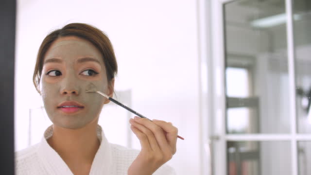 Beautiful Woman Applying A Facial Mask By Herself