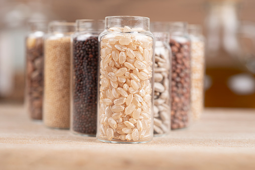 various grains in small jars - cereals