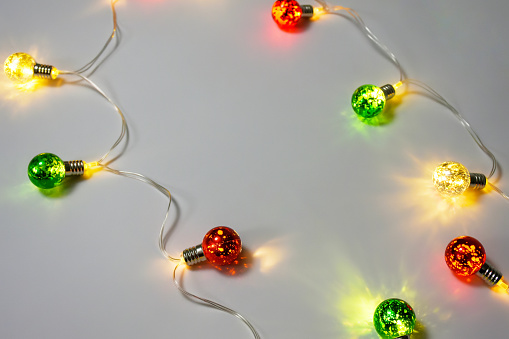 Christmas lights on the white background with copy space