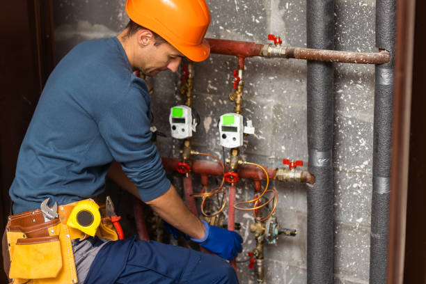 istock Maintenance engineer checking technical data of heating system equipment in a boiler room. Plumber installing pressure meter for house heating system 1447133100