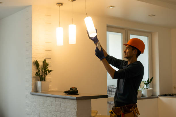 Electrician installs lamp lighting and spot loft style stock photo