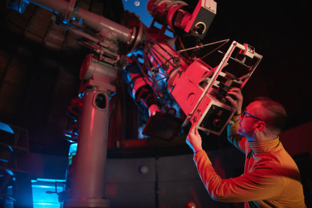 istock Astronomer with a big astronomical telescope in observatory doing science research of space and celestial objects. 1447134765
