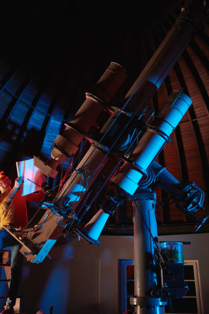 istock Astronomer with a big astronomical telescope in observatory doing science research of space and celestial objects. 1447134793