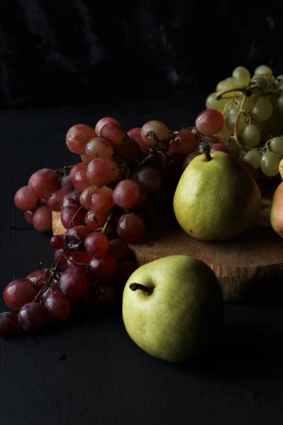 istock fruits, grapes, pears on a black background 1447134902