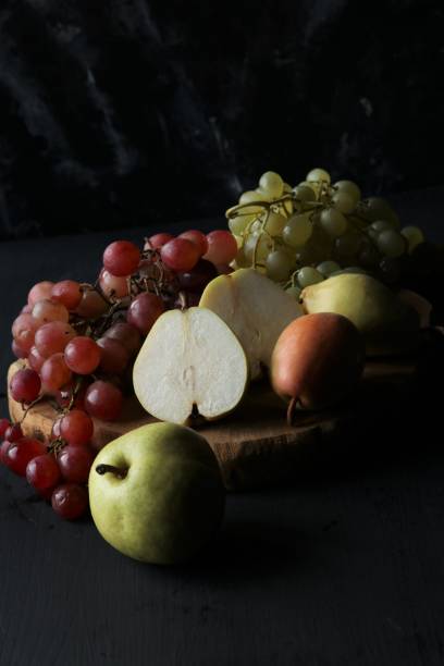 istock fruits, grapes, pears on a black background 1447134903