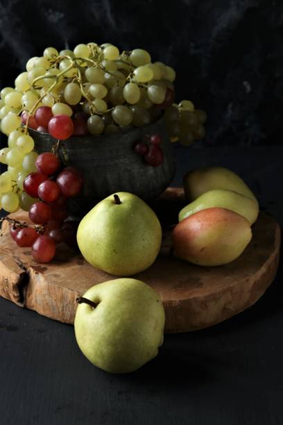 istock fruits, grapes, pears on a black background 1447134915