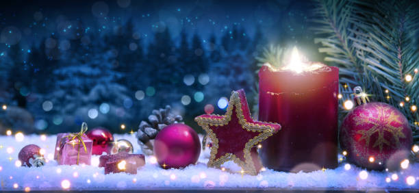 istock Advent candle and christmas decoration in atmospheric light. 1447135178