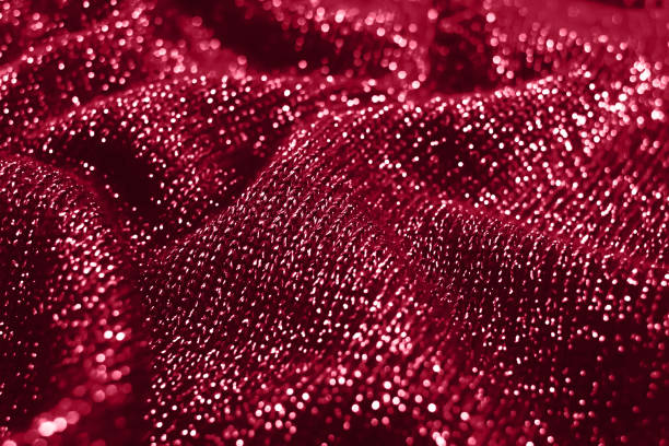 istock Abstract shiny knitted fabric background with copy space. Red fashion glittery textile 1447138465