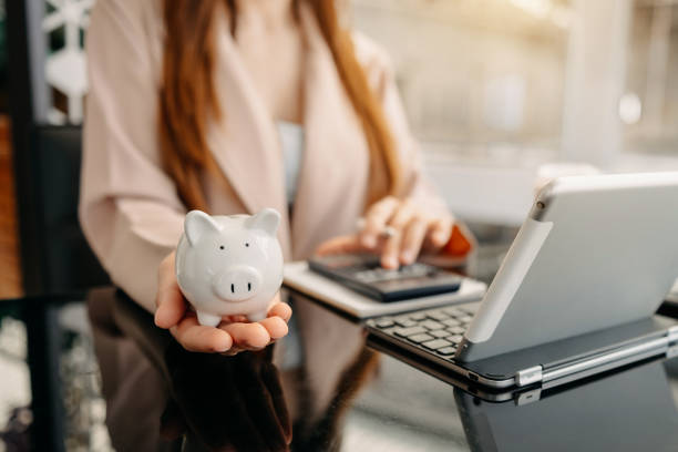 business 
Woman hand holding coin with pig piggy bank. Saving and financial accounts concept Woman hand holding coin with pig piggy bank. Saving and financial accounts concept 2632 stock pictures, royalty-free photos & images