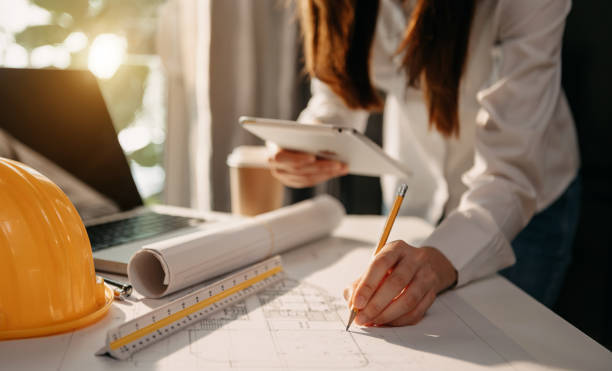 istock Creative architect projecting on the big drawings in the dark loft office 1447139666
