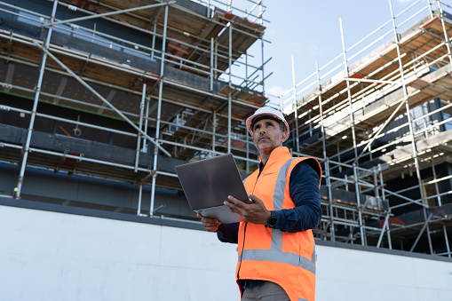 civil engineer holding a laptop