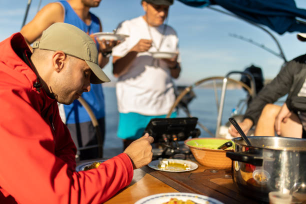 istock Group of man eating on a sailing boat 1447140679
