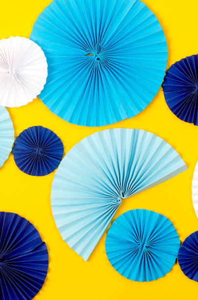 istock Blue paper fan medallion on yellow background. 1447141862