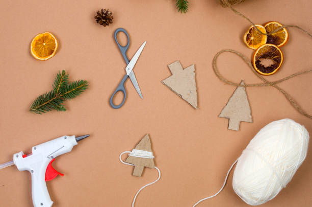 istock process creating crafts for christmas from cardboard and yarn.  Ecofriendly xmas. 1447141864