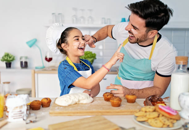 istock Father and daughter cooking together in a kitchen 1447144079