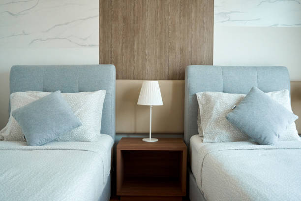 istock Apartment interior hotel with two single beds and bedside lamps 1447145341