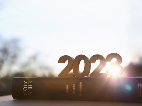 Bright shining sun and bible book and new year sunrise 2023