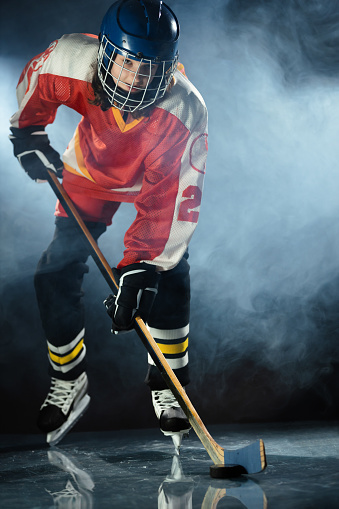 Sportswoman wearing hockey equipment.