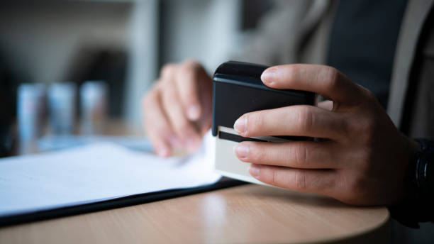 istock Close-up Businessman stamping documents 1447151156