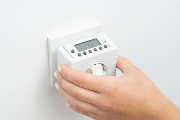 istock Turning on outlet computer that counts and saves energy, turns on and off socket 1447151848