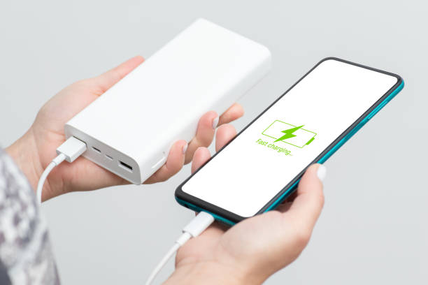 istock Smartphone in womans hands is charging from powerbank 1447151851