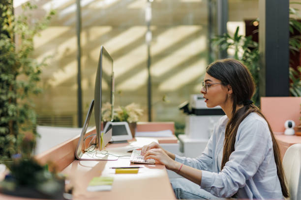 istock Side view of a concentrated woman typing something, working online. 1447152086