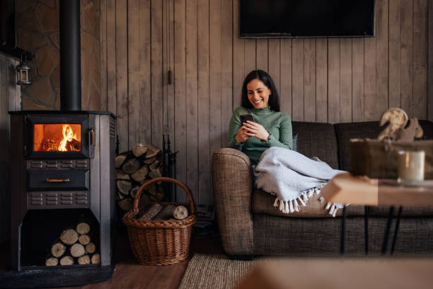 istock Happy woman enjoying at home, using a mobile phone, and being alone. 1447152123