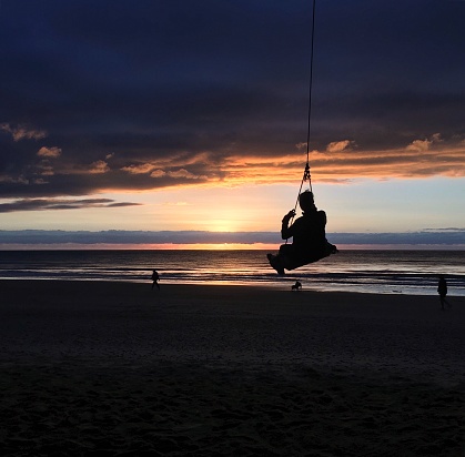 Swinging at sunrise at Cow Bay Beach, Australia.