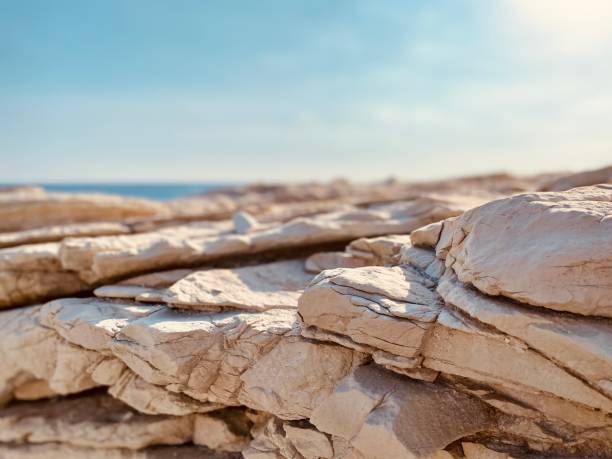 istock White rock stone focus texture with sea background in distance 1447152200