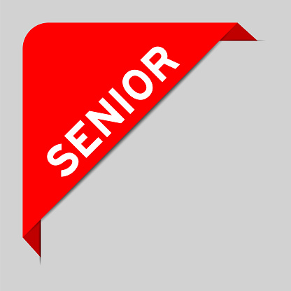 Red color of corner label banner with word senior on gray background