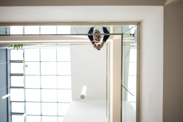 istock Businessman checking energy consumption in office building using smart phone 1447154228